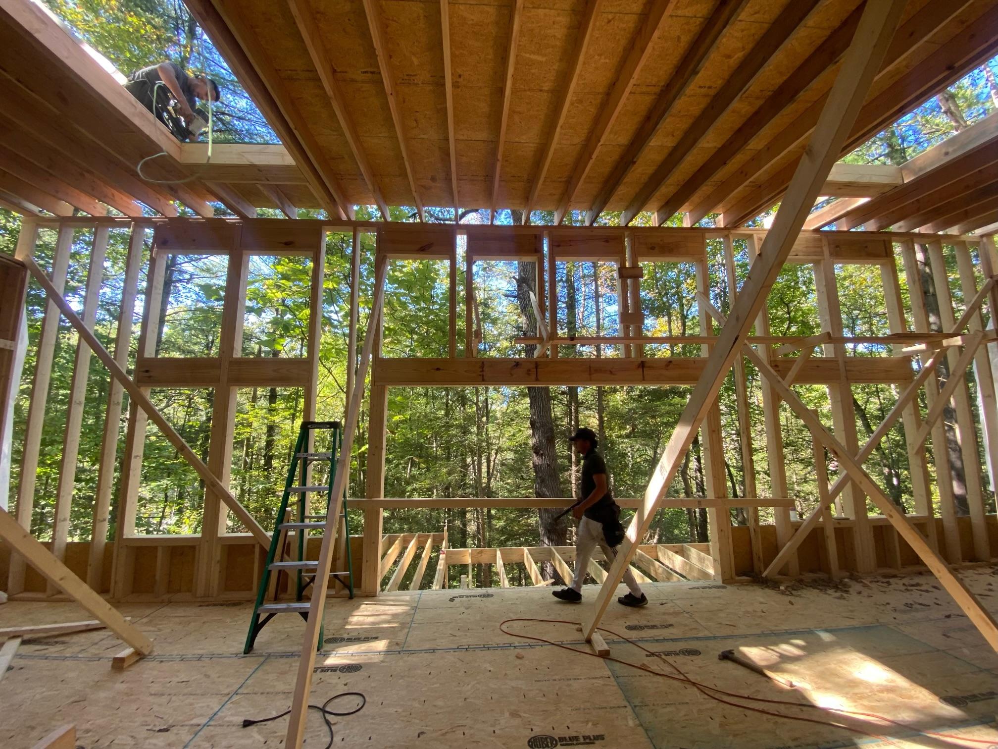 a man walking in a wood frame cabin build at the red river gorge ky